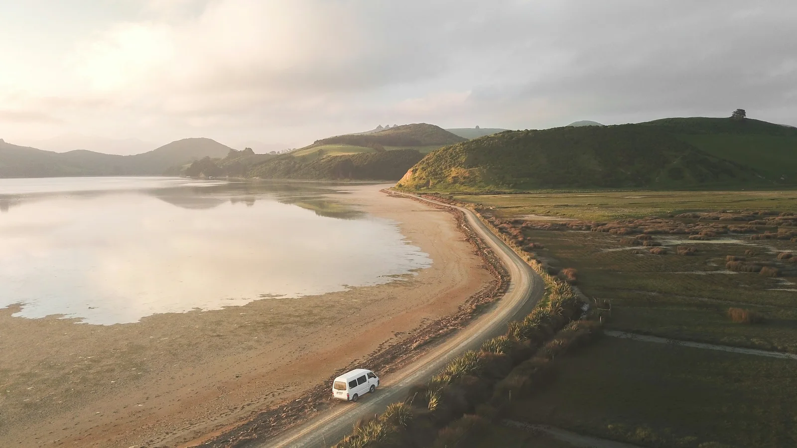 Visitor checking an overseas licence beside a campervan